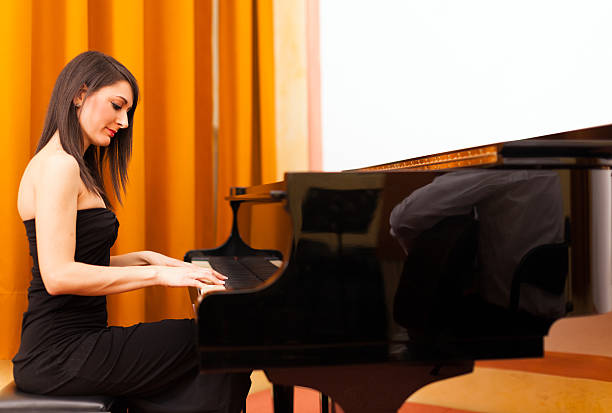 istock Woman playing piano 513634879