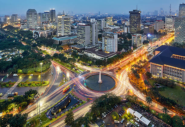 Jakarta Intersection Jakarta city view at afternoon, while the road condition was so active. its taken on rush hour time in the afternoon. jakarta stock pictures, royalty-free photos & images