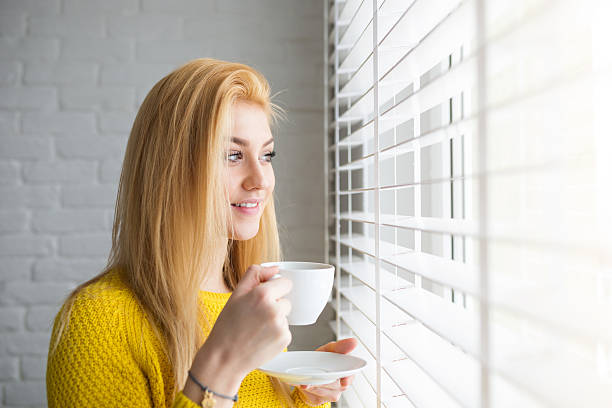 istock Pretty girl looking outside the window 513636584