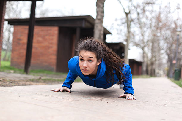 istock Young female athlete doing push-ups. 513638586