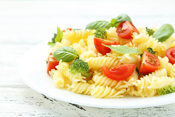 istock Delicious pasta on plate on white wooden background 513639216