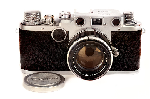 Montreal, Canada - March 03, 2016 : Leica classic vintage IIc camera circa 1948-51 with Canon screw in lens and Canon lens cap seen from the front.