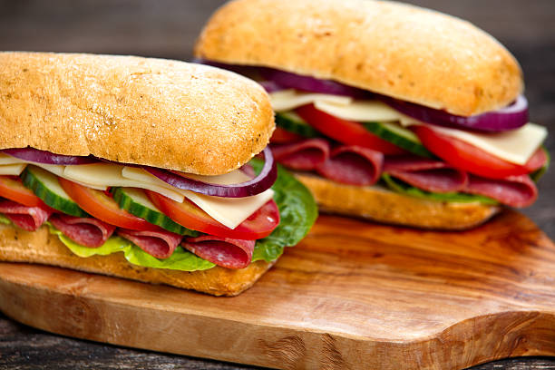 istock Sandwich with lettuce, tomatoes, cucumber, onion, salami and cheese 513639746
