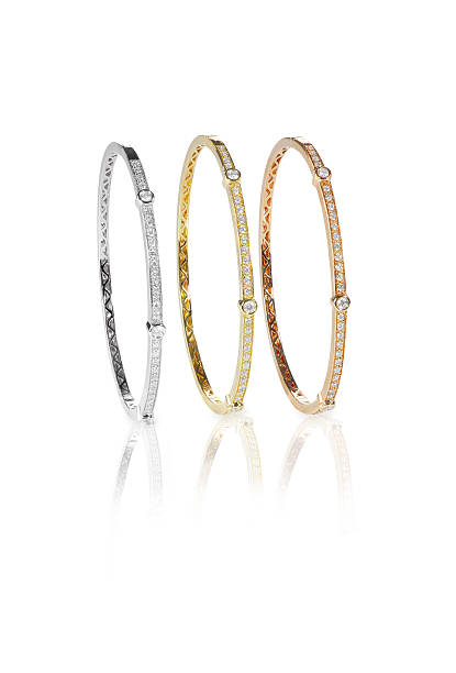 istock Set of three colored gold diamond bangle bracelets standing upri 513640514