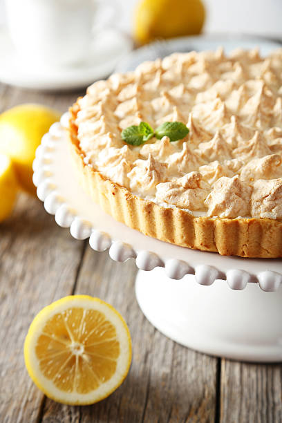 istock Lemon meringue pie on cake stand on grey wooden background 513640570