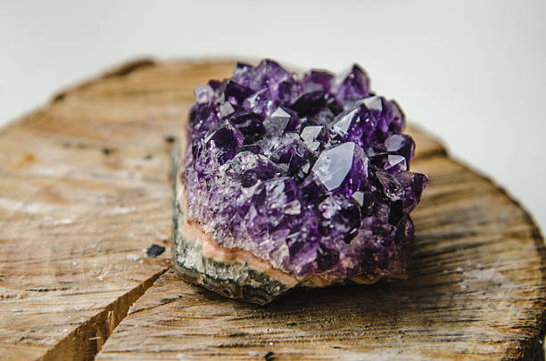 istock Raw amethyst rock with reflection on natural wood crystal  ametist 513640830