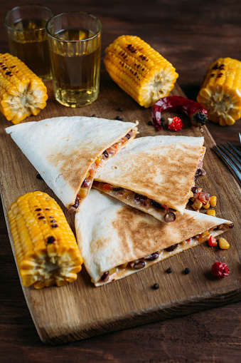 Mexican vegetarian quesadilla with cheese on a dark background