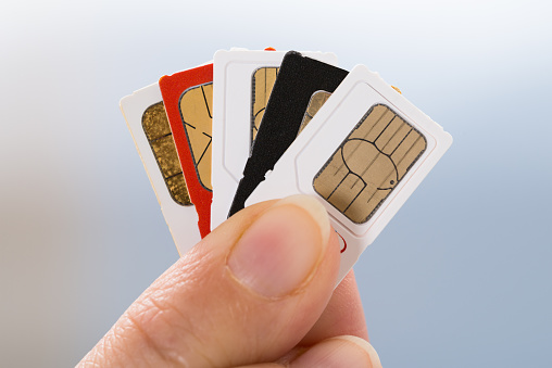 Close-up Of Person Hand Holding Four Phone Sim Cards