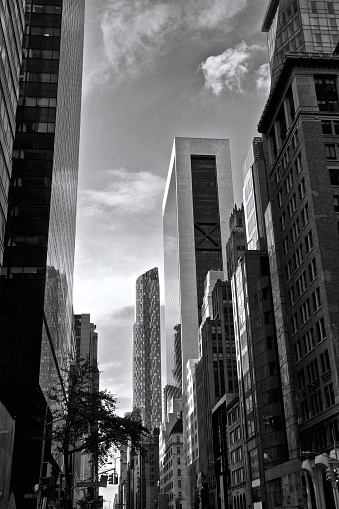 A cityscape scene of both older, 20th century and newer, 21st century skyscrapers seen as viewed looking Westward across 57th Street near Madison Avenue in Midtown Manhattan, New York City, USA.