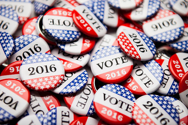 Election Vote Buttons Close up of Vote 2016 election buttons, with red, white, blue and stars and stripes. 2016 stock pictures, royalty-free photos & images