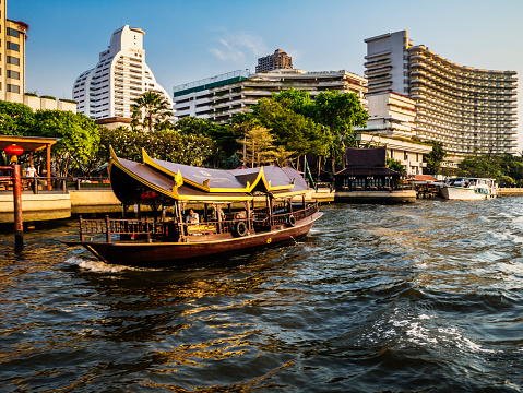 Bangkok, Thailand - February 4, 2016: Chao Phraya river Bangkok Thailand. This is the river that crosses the city and has a big ramification of smaller canals. Here the Chao Phraya is a major transportation artery for a vast network of river buses, cross-river ferries and water taxis, also known as longtails. More than 15 boat lines operate on the rivers and canals of the city, including commuter lines.
