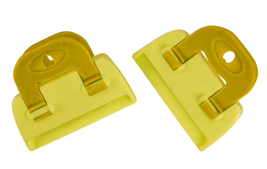Yellow plastic clamps isolated on white background. Clipping path included for your design.