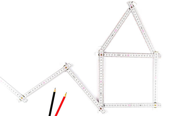 white meter tool forming a house, two drawing pencils white meter tool forming a house, two drawing pencils on white background turnkey project stock pictures, royalty-free photos & images