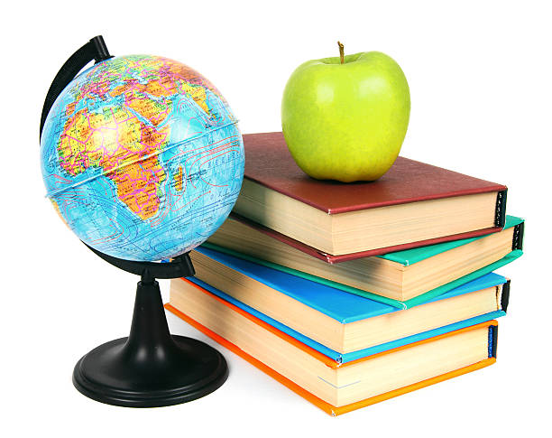istock Books, an apple and globe. On white background. 513647091