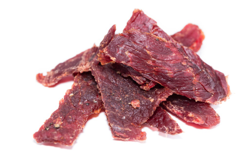 Portion of Beef Jerky (close-up shot) on pure white background