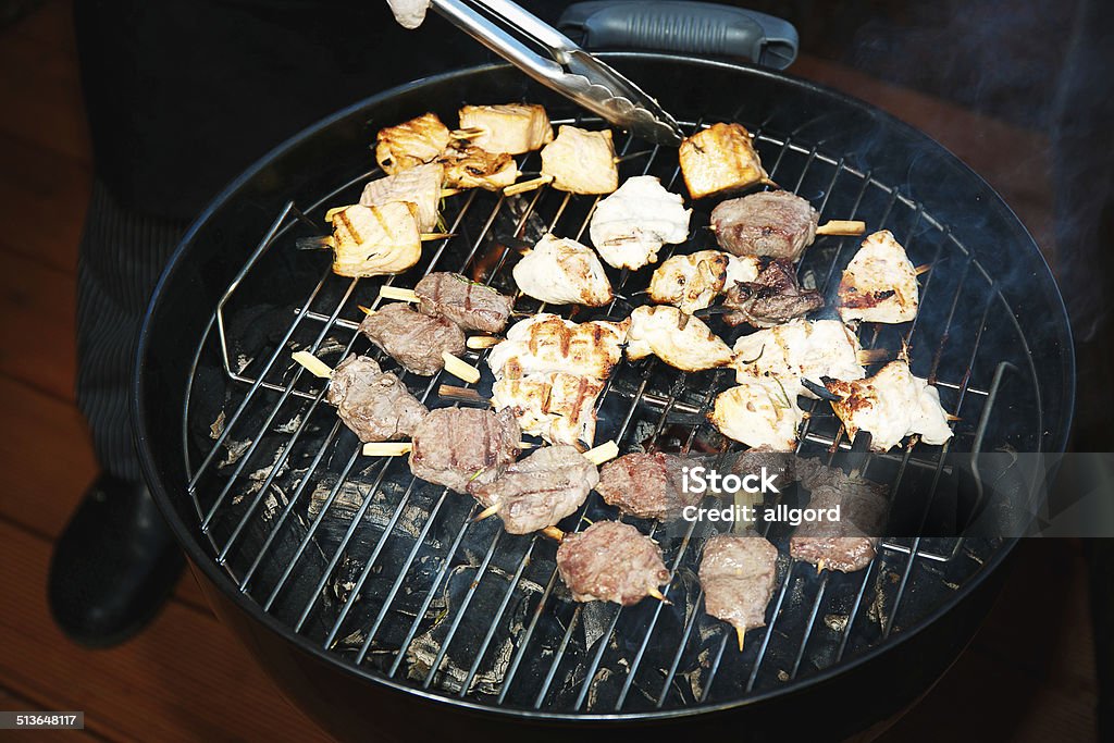 Pieces of meat on the grill Fresh meat preparing on grill Barbecue - Meal Stock Photo