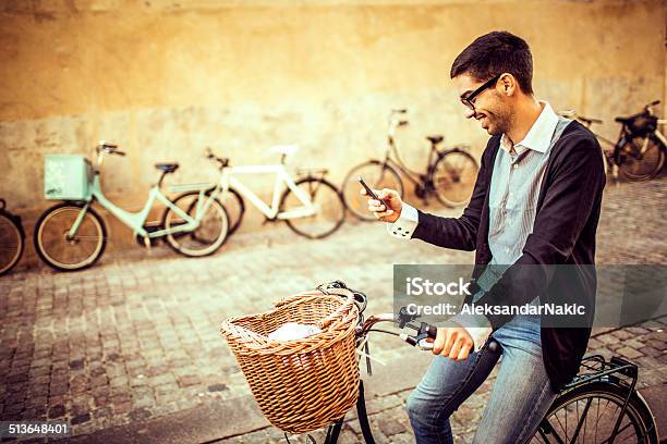 Using A Smart Phone On The Bicycle Stock Photo - Download Image Now - 20-29 Years, Activity, Adult