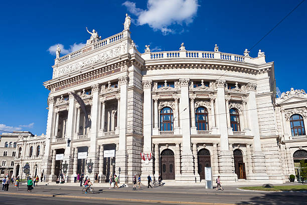 Burgtheater In Vienna, Austria Vienna, Austria - June 22, 2014:  People walk by in front of the historic Burgtheater in downtown Vienna, Austria. burgtheater vienna stock pictures, royalty-free photos & images