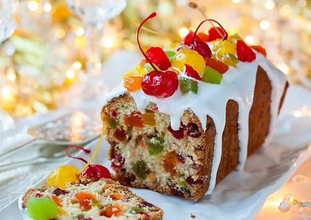 Christmas fruitcake with sugar icing and candied fruits