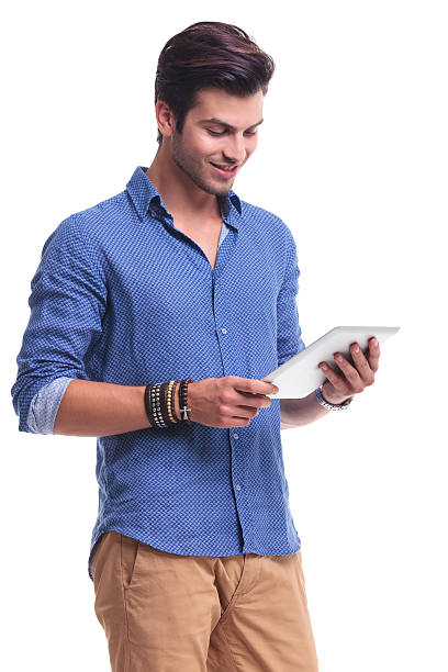 istock happy casual man reading on a tablet 513649553