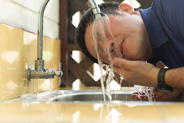 istock Middle aged man washes his face in front of bathroom. 513650001