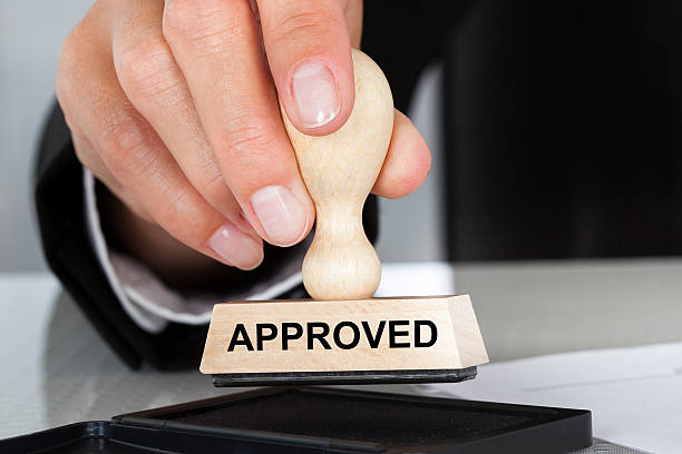istock Hand Holding Rubber Stamp With Approved Sign 513652277