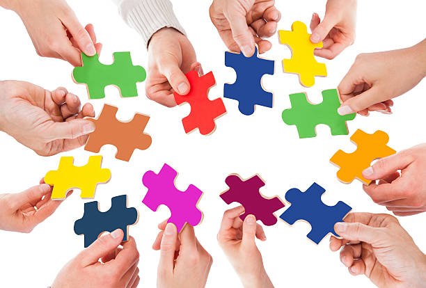 istock Business People Holding Colorful Jigsaw Pieces 513652283