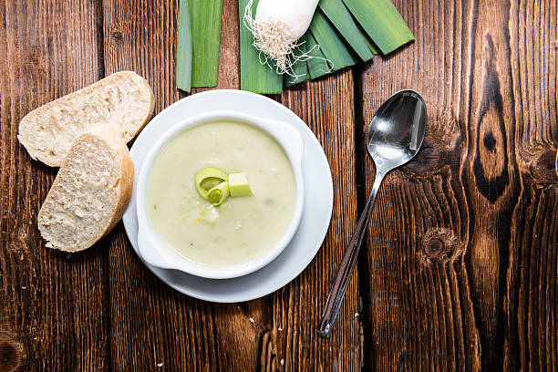 Portion of Leek Soup in a small bowl on dark wooden background