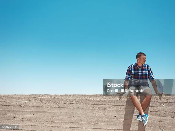 Man Sitting On The Wall Stock Photo - Download Image Now - Accuracy, Achievement, Adult