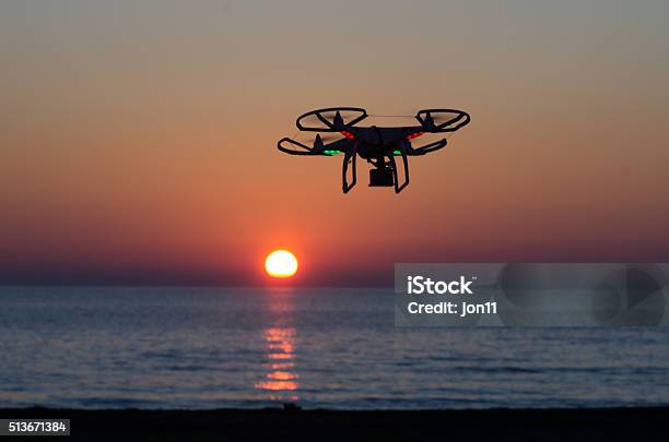 Flying Drone With Camera On The Sky At Sunset Stock Photo - Download Image Now - Aerial View, Billions - Quantity, Camera - Photographic Equipment