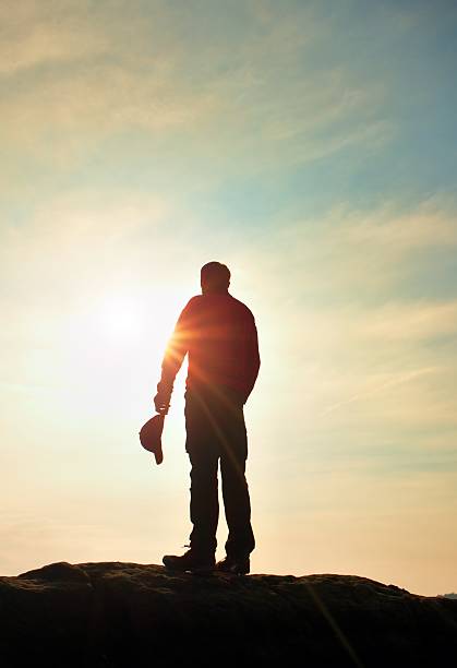 istock Hiker in red sweatshirt with red  cap on rocky peak. 513672224