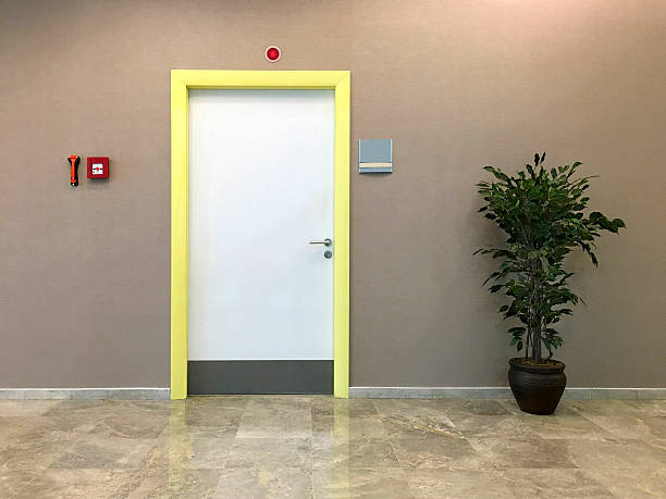 Office Room Door, Fire Alarm and Plant Office Room Door, Fire Alarm and Plant on Corridor. doorknob photos stock pictures, royalty-free photos & images