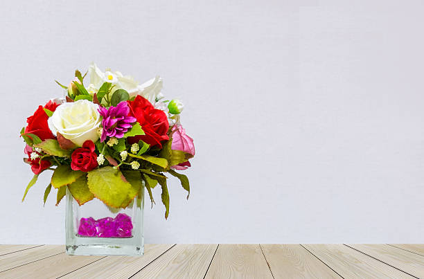 Copy space of fake flower bush in flowerpot on table with bokeh. Concept for interior design,cafe and restaurant decoration, space for text.