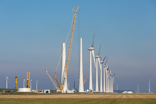 Construction site of new Dutch wind farm in agricultural landscape