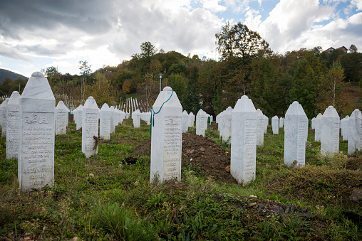 Potočari, Bosnia and Herzegovina - October 10, 2013: Autumn day at the Srebrenica-Potočari Genocide Memorial and Cemetery, where the remains of more than 6000 Bosnian Muslims killed by Bosnian Serbs have been laid to rest.