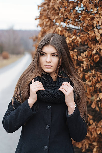 istock beautiful girl near autumn tree 513675900
