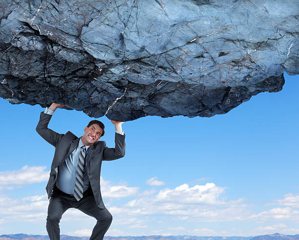 istock Businessman Attempting To Lift And Support Large Rock 513678560