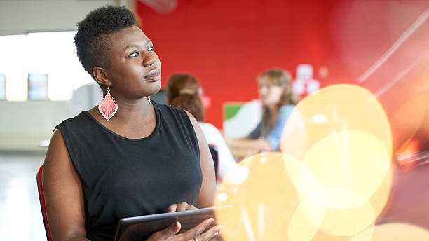 istock Confident female designer working on a digital tablet in red 513678926