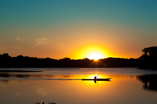Subject: Kayaking in Lake of the Isles of Minneapolis, Minnesota at sunset.