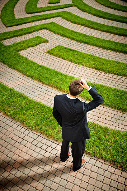 istock Maze with Confused Businessman Pondering Strategic Path and Occupation Solutions 513679130