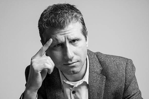 istock pensive attractive businessman portrait looking down 513680874