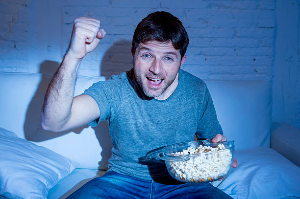istock young happy man watching television sport match cheering victory 513680892