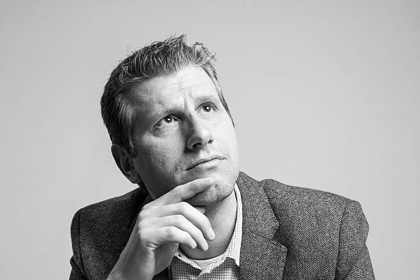 istock thinking attractive businessman portrait looking up 513681038