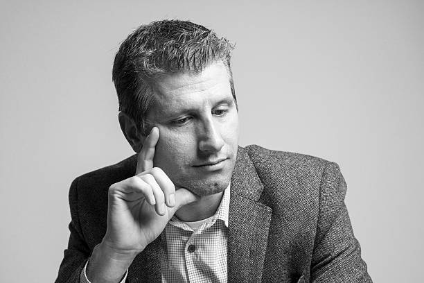 istock pensive attractive businessman portrait looking down 513681532
