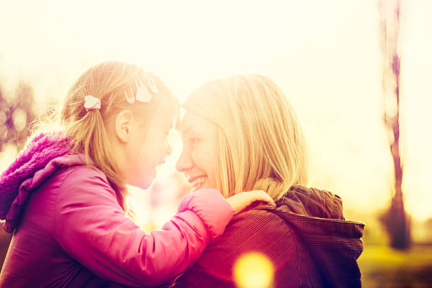 istock Mother and daughter outdoors at sunset 513682638