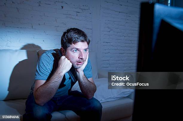 Television Addict Man Watching Tv Holding Remote Control Mesmerized Stock Photo - Download Image Now