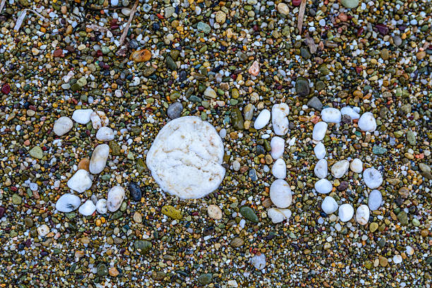 istock Stones on sand closeup. New Year. 2016. Beach. Copy space 513684654