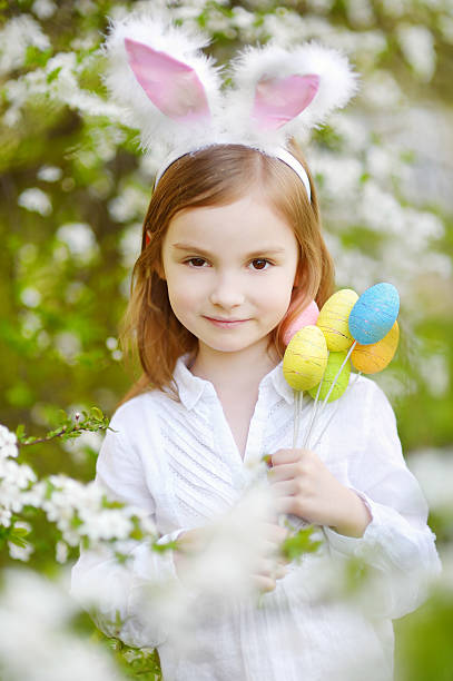 istock Adorable little girl wearing bunny ears on Easter 513685696