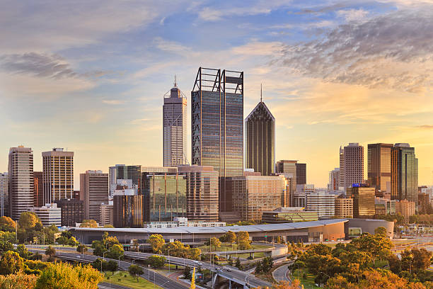 Perth CBD Gold SUn close Perth city CBD towers close up view from lookout of Kings park at sunrise during gold sun light hour. perth australia photos stock pictures, royalty-free photos & images