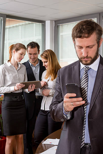 istock Businessman using mobile phone in a meeting 513686994